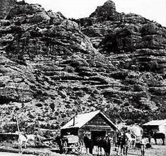 Man and Horses in front of Cabin in Echo Valley